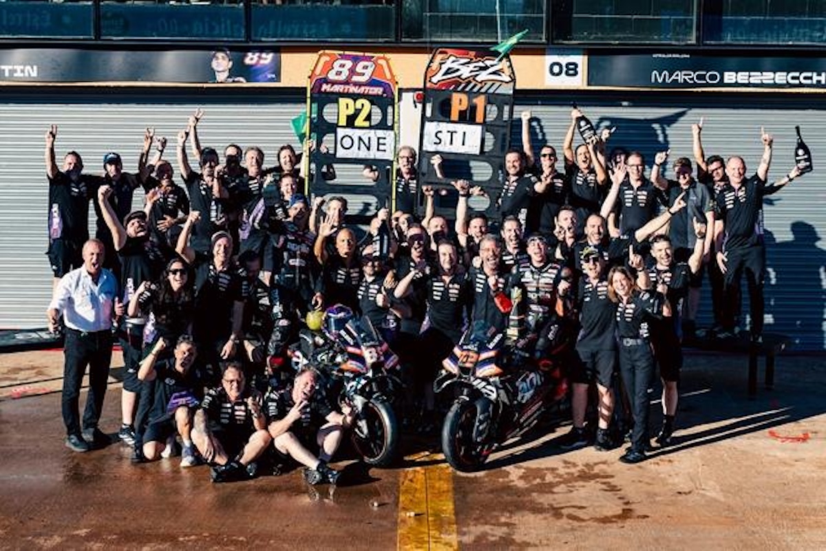 Aprilia Racing team celebrates the Brazilian MotoGP 2026 podium with MARTINATOR and BEZZECCHI signs at Goiania